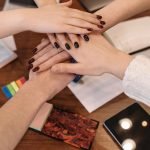 Hands stacked together showing unity and support
